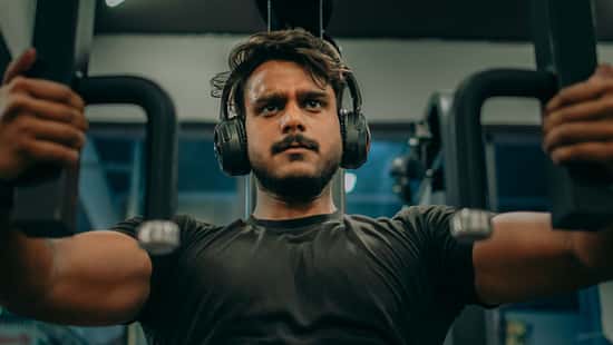 Determined Fitness Enthusiast Working Out on Chest Press Machine – Intense Gym Training Concept