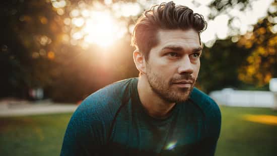 Healthy young man standing outdoors in park