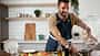 Happy,Man,In,Kitchen.,Young,Man,Preparing,Delicious,Food.