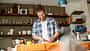 Young man preparing food at home, slicing bread