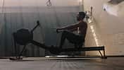 Male,Using,Rowing,Machine,At,Fitness,Club.,Young,Man,Doing