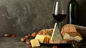 Cheese,,Bread,,Red,Wine,,And,Walnuts,On,A,Kitchen,Table.