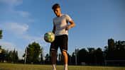 play,freestyle,practice,competition,balance,action,stadium,goal,athlete,juggle,active,field,background,person,success,soccer ball,male,hobby,game,young,exercise,effort,training,trick,sportsman,sun,summer,ball,uniform,skill,man,football player,leisure,meadow,player,soccer,move,green,motion,nature,control,football,lifestyle,outdoor,sunlight,footballer,kick,healthy,sunset,sport Professional,Footballer,Juggling,Soccer,Ball,On,Stadium,At,Sunset.,Young