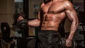 Power,Athletic,Man,In,Training,Pumping,Up,Muscles,With,Dumbbell.