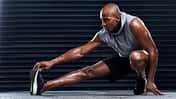 Male,Athlete,,Exercise,And,Stretching,Leg,With,Hand,For,Sports,