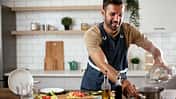 Happy,Man,In,Kitchen.,Young,Man,Preparing,Delicious,Food.