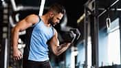 Muscular,Sportsman,With,Strong,Body,Lifting,Heavy,Dumbbell,,Empty,Space