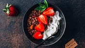 Chocolate,Granola,With,Irish,Skyr,And,Strawberries,On,Dark,Background.