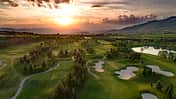 Golf course beautiful Aerial view of golf field landscape with sunset view.
