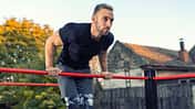 Young,Muscular,Man,Doing,Calisthenics,Outside,Lifting,Himself,Above,The