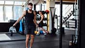 Young man skipping rope in the gym